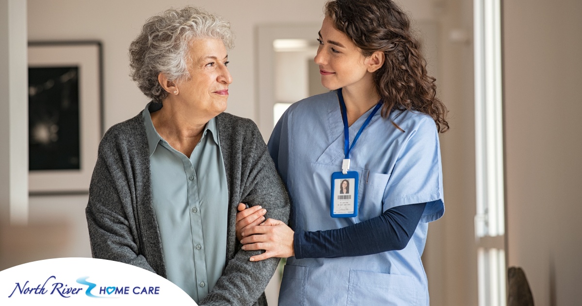 A caregiver and client smile at each other as the caregiver helps the client, representing emotional intelligence in caregiving.