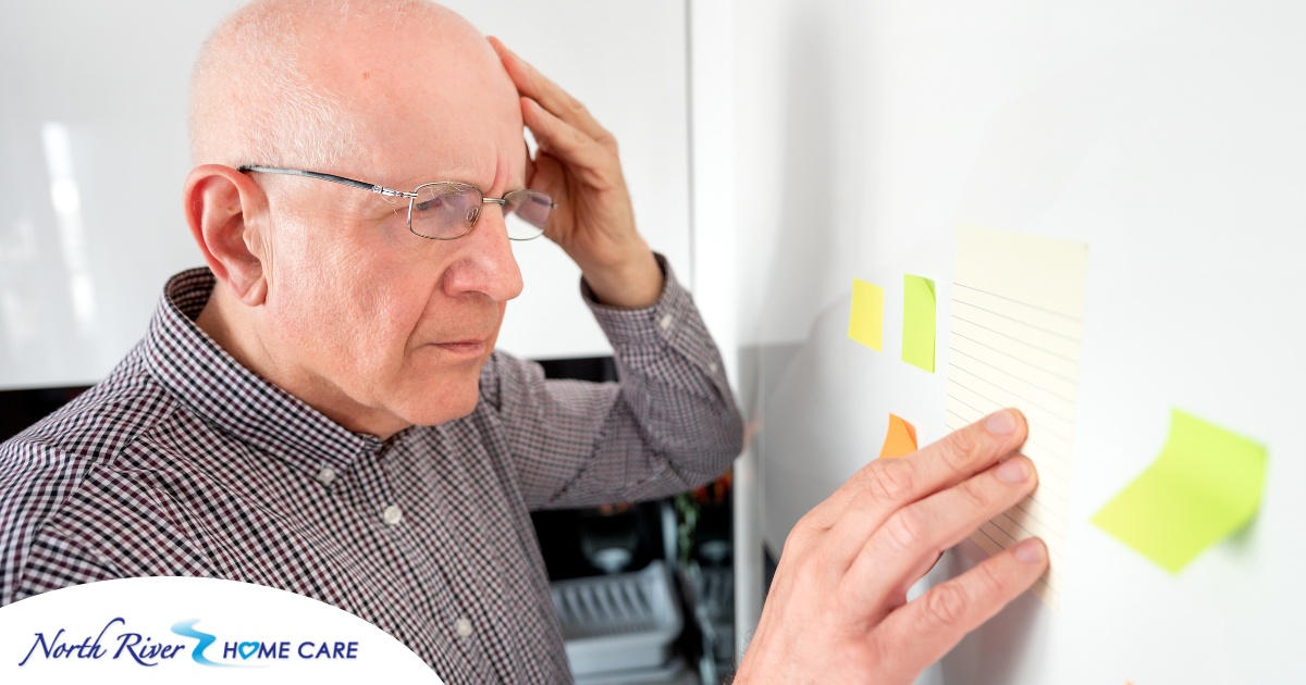 A senior looks at a board confused, representing one of the potential signs of dementia.