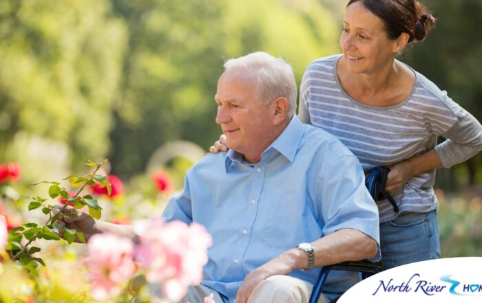 A caregiver takes a senior outside to visit a garden, highlighting one idea for senior activities.