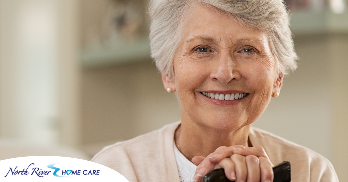 An older woman with healthy teeth smiles, representing good dental hygiene.