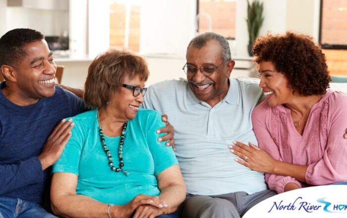 A couple sits with aging parents and enjoys their time together.