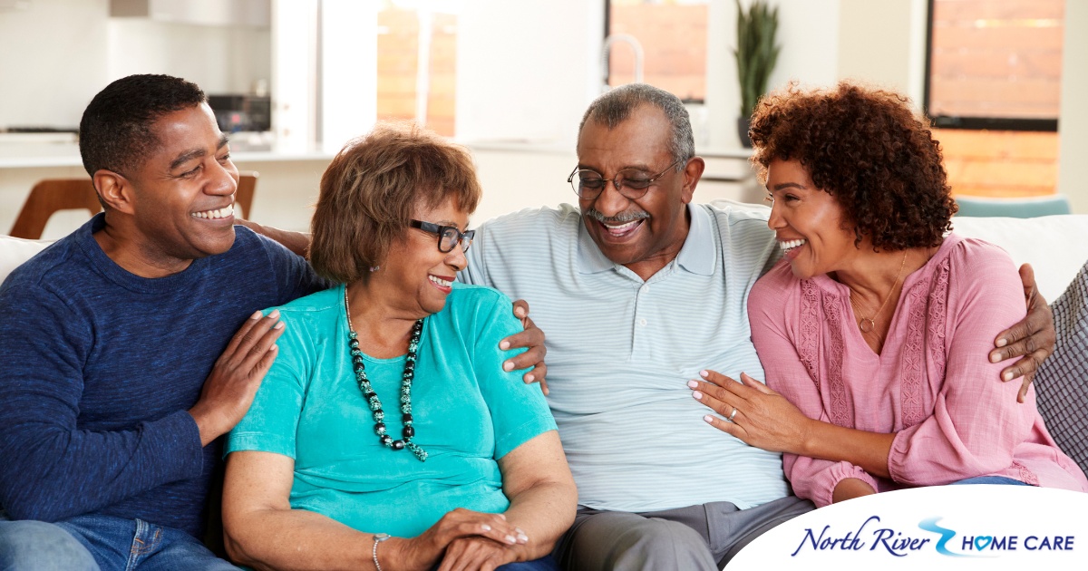 A couple sits with aging parents and enjoys their time together.