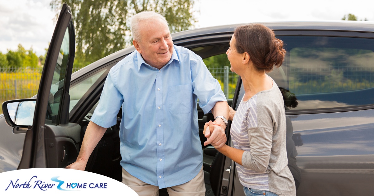 A caregiver helps a senior carefully get out of the care, representing the safety that those who work in home care should strive for.