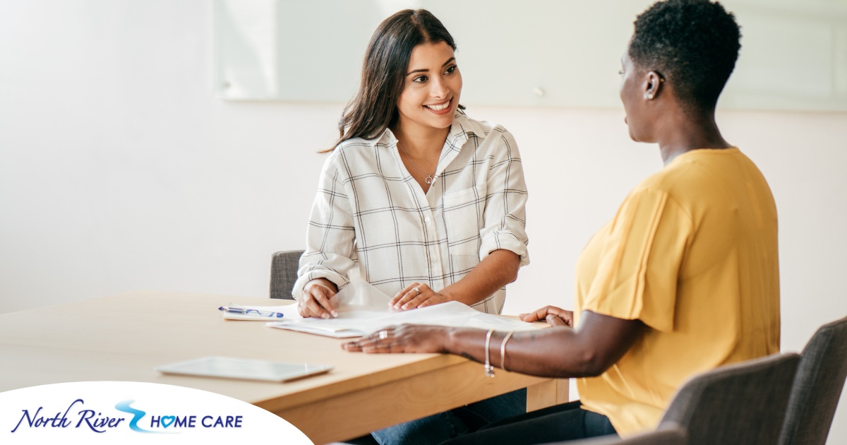 A woman smiles while being interviewed representing how well a caregiver interview can go when good questions are asked.