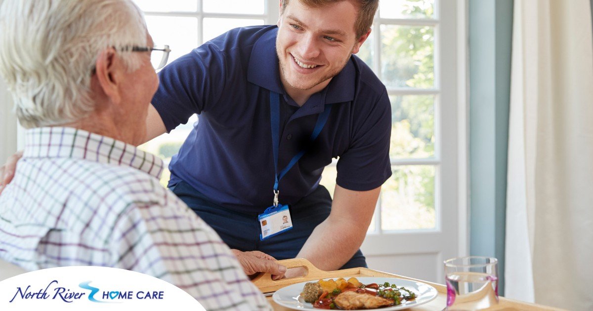 Professional caregiving involves helping clients with iADLs and ADLs as demonstrated by this caregiver helping a client by bringing a meal.
