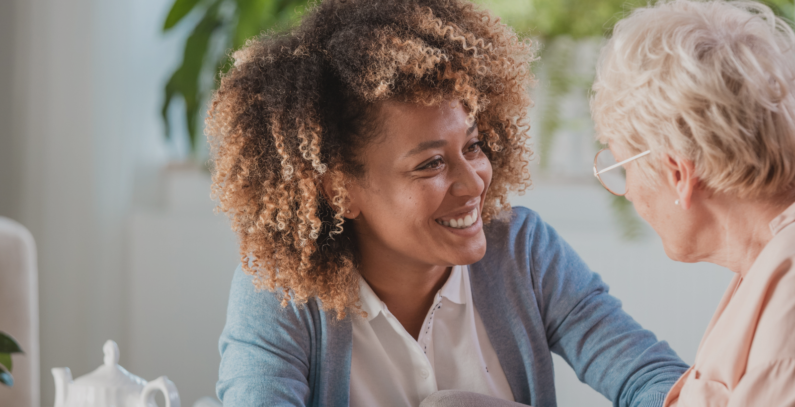 home health aide smiling at older woman