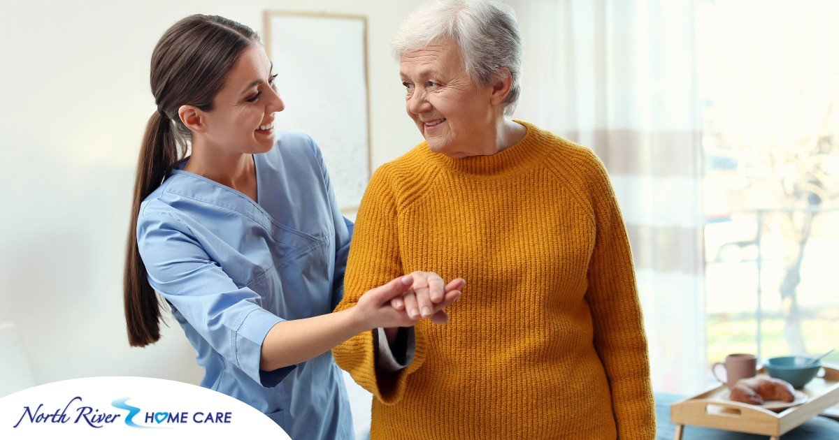 A caregiver helps a client get around, demonstrating one of the job duties of a caregiver.