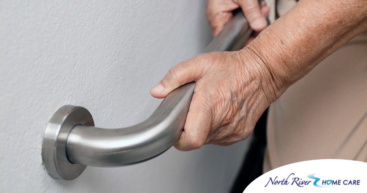 An older adult uses a grab bar representing one of the home modifications that is helpful for fall prevention for elderly adults.