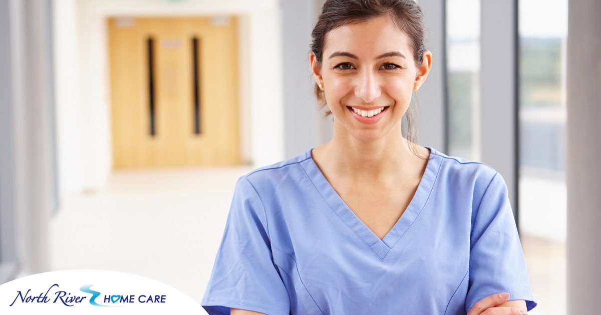 A woman in scrubs smiles, representing the good results that can come when caregivers branch out to become CNAs.