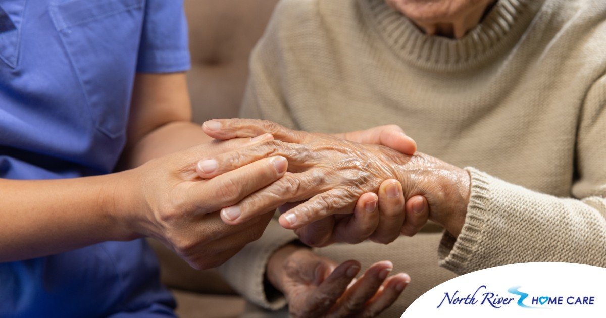 A care provider examines an older adult’s fingers, representing what would happen in an examination for rheumatoid arthritis.