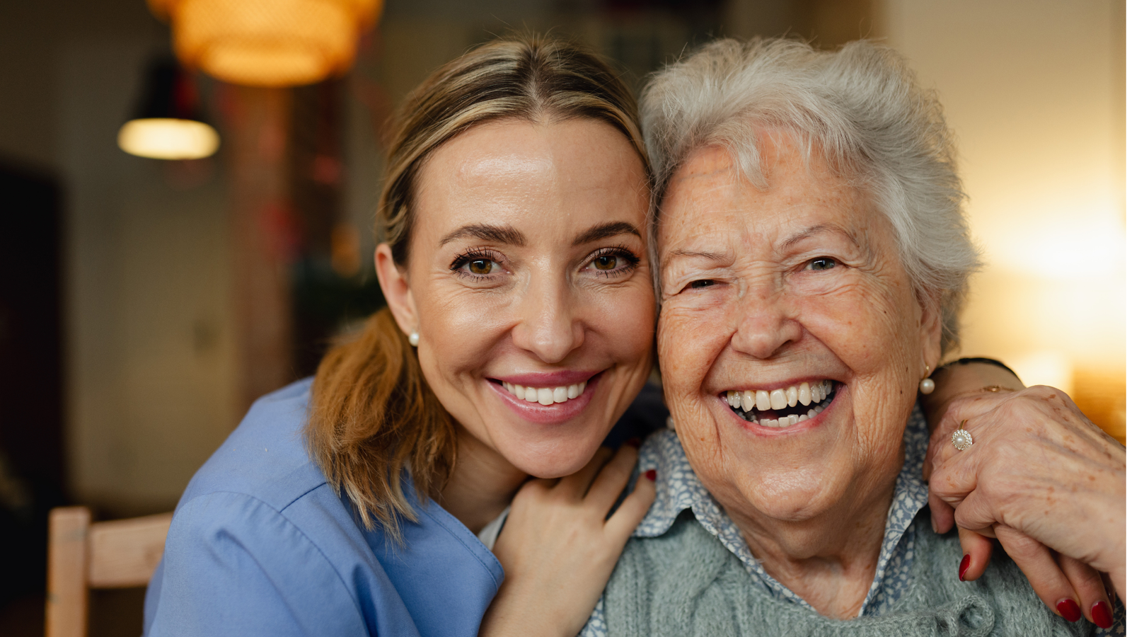 caregiver laughing with senior woman
